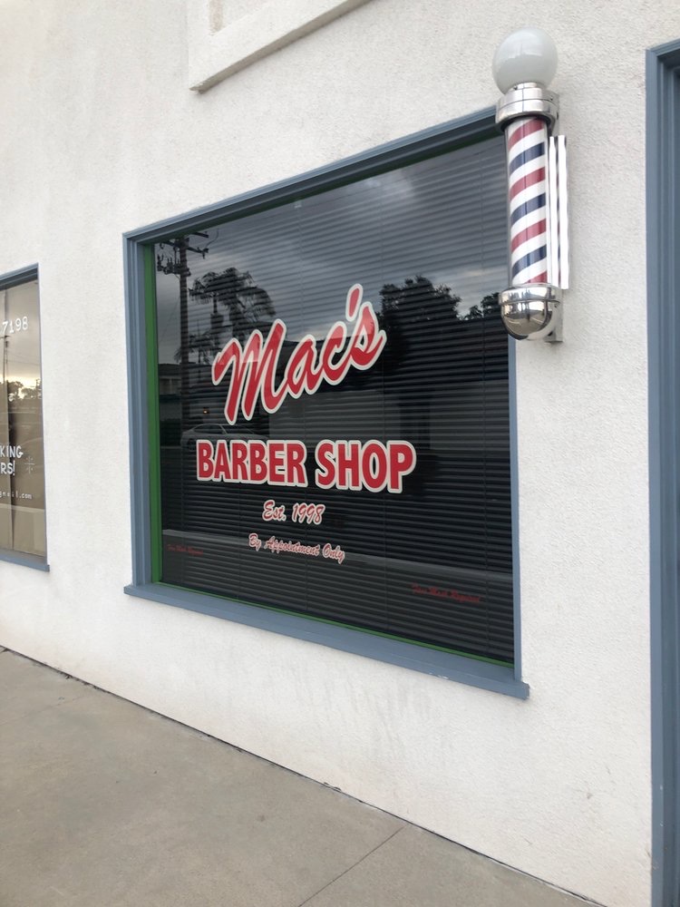 Mac's Barber Shop exterior with its window lettering and barber pole