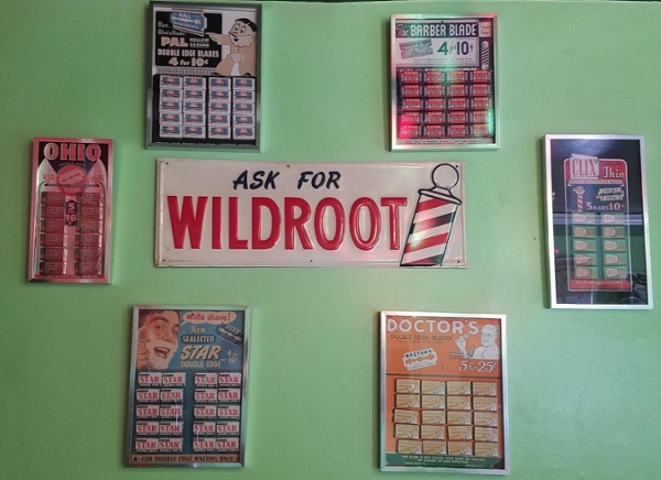 Vintage haircut chart and appointment-only door inside Mac's Barber Shop